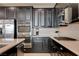 Modern kitchen with stainless steel appliances, dark cabinets, and white backsplash at 10512 Mann St, Las Vegas, NV 89141