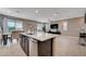 Open-concept layout with kitchen island, modern appliances, and dining area featuring sliding glass door access at 10512 Mann St, Las Vegas, NV 89141
