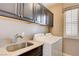 A laundry room featuring a sink, washer, dryer, and cabinets at 10512 Mann St, Las Vegas, NV 89141