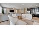 Open-concept living room with a ceiling fan, an adjacent modern kitchen, and comfortable seating at 10512 Mann St, Las Vegas, NV 89141