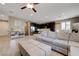 Spacious living area open to kitchen, featuring tile floors and comfortable seating with a gray sectional at 10512 Mann St, Las Vegas, NV 89141