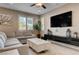 Comfortable living area with a large sectional, neutral tones, and a modern entertainment center at 10512 Mann St, Las Vegas, NV 89141