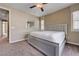 Carpeted main bedroom with a ceiling fan and natural light at 10512 Mann St, Las Vegas, NV 89141