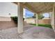 Charming covered patio with string lights, perfect for outdoor dining and entertaining with gravel and turf accents at 10512 Mann St, Las Vegas, NV 89141