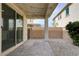 Charming covered patio with pavers, gravel, and string lights, creating a cozy outdoor retreat at 10512 Mann St, Las Vegas, NV 89141