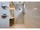 Walk-in shower with gray tiling, dual shower heads, and built-in shelving at 10512 Mann St, Las Vegas, NV 89141