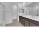 Elegant bathroom with double vanity, framed mirrors and tiled floors, offering luxury and functionality at 11407 Ethereal Landing Ave, Las Vegas, NV 89138