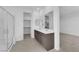 Bright bathroom showcasing a double sink vanity, shower, and walk-in closet access at 11407 Ethereal Landing Ave, Las Vegas, NV 89138