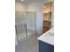 Bathroom featuring a tiled shower with bench and a walk-in closet at 11407 Ethereal Landing Ave, Las Vegas, NV 89138