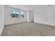 Bright carpeted bedroom with two windows showing exterior view at 11407 Ethereal Landing Ave, Las Vegas, NV 89138