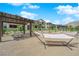 Inviting community space with shaded seating, hammocks and lush landscaping, perfect for relaxation at 11407 Ethereal Landing Ave, Las Vegas, NV 89138
