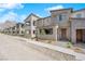 Exterior view showcasing a row of modern townhomes with desert landscaping and mountain views at 11407 Ethereal Landing Ave, Las Vegas, NV 89138