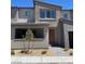 Contemporary townhouse featuring desert landscaping and a neutral color palette at 11407 Ethereal Landing Ave, Las Vegas, NV 89138