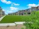Townhome community with grassy common areas and desert landscaping at 11407 Ethereal Landing Ave, Las Vegas, NV 89138