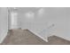 Carpeted hallway with white wood railings and doors leading to other rooms at 11407 Ethereal Landing Ave, Las Vegas, NV 89138