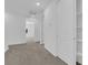 Hallway view with carpet flooring, white trim, and open doorway at 11407 Ethereal Landing Ave, Las Vegas, NV 89138
