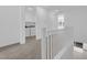 Upstairs hallway featuring laundry room and plenty of natural light, enhancing functionality and brightness at 11407 Ethereal Landing Ave, Las Vegas, NV 89138