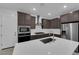 Well-equipped kitchen featuring stainless steel appliances, white countertops, and a central island at 11407 Ethereal Landing Ave, Las Vegas, NV 89138