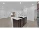 Open kitchen with a center island and easy access to both a powder room and an outside patio at 11407 Ethereal Landing Ave, Las Vegas, NV 89138