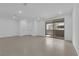 An open living space featuring neutral tile floors and access to an outdoor patio at 11407 Ethereal Landing Ave, Las Vegas, NV 89138