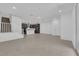 Open-concept living area with staircase, dark cabinets, tile flooring, and natural light at 11407 Ethereal Landing Ave, Las Vegas, NV 89138