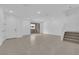 Bright living area offers a view of an outdoor balcony with neutral flooring and access to the stairway at 11407 Ethereal Landing Ave, Las Vegas, NV 89138