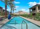 Community pool with lounge seating, mature landscaping, and mountain views at 11407 Ethereal Landing Ave, Las Vegas, NV 89138