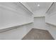 Expansive walk-in closet with wooden rods and shelving, maximizing organization and storage at 11407 Ethereal Landing Ave, Las Vegas, NV 89138