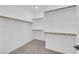 Spacious walk-in closet featuring wood rods and shelving for organization at 11407 Ethereal Landing Ave, Las Vegas, NV 89138