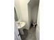 Powder room with a pedestal sink, oval mirror, and tiled floor at 11423 Ethereal Landing Ave, Las Vegas, NV 89138