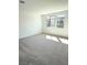 A bright, carpeted bedroom features three windows, recessed lighting and ample room at 11423 Ethereal Landing Ave, Las Vegas, NV 89138