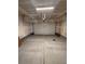 Spacious two car garage with concrete flooring and an automatic overhead door at 11423 Ethereal Landing Ave, Las Vegas, NV 89138