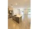 Open floor plan featuring a kitchen island with stainless steel appliances at 11423 Ethereal Landing Ave, Las Vegas, NV 89138