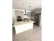 Modern kitchen featuring gray cabinets, stainless steel appliances, quartz countertops, and a central island at 11423 Ethereal Landing Ave, Las Vegas, NV 89138
