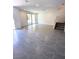 Spacious open-concept living area featuring sleek tile floors and a sliding glass door to the outdoor space at 11423 Ethereal Landing Ave, Las Vegas, NV 89138