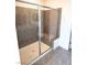 Modern shower with glass door and bench in neutral ceramic tile at 11423 Ethereal Landing Ave, Las Vegas, NV 89138