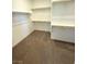 A large walk-in closet with custom shelving and plush carpeting provides ample storage space at 11423 Ethereal Landing Ave, Las Vegas, NV 89138