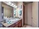 Bright bathroom features a cherry vanity, granite countertops, and ample storage space at 1150 N Buffalo Dr # 1022, Las Vegas, NV 89128