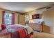 Comfortable bedroom offers a king-sized bed, plush carpet, and convenient access to the dining area at 1150 N Buffalo Dr # 1022, Las Vegas, NV 89128