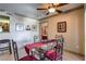 The dining area features a modern glass table, red chairs, and a decorative ceiling fan at 1150 N Buffalo Dr # 1022, Las Vegas, NV 89128