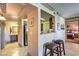 Hallway featuring granite countertops, tiled flooring, and views of the living room and bedroom at 1150 N Buffalo Dr # 1022, Las Vegas, NV 89128