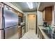 Kitchen showcasing stainless appliances, a washer/dryer room and beautiful granite counter tops at 1150 N Buffalo Dr # 1022, Las Vegas, NV 89128