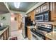 Efficient kitchen featuring stainless steel appliances, granite countertops, and warm wood cabinetry at 1150 N Buffalo Dr # 1022, Las Vegas, NV 89128