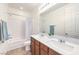 Bright bathroom features a double sink vanity and shower-tub combo at 12536 Blissful Sky St, Las Vegas, NV 89138