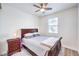Cozy bedroom features a ceiling fan, a window, and a dark wood bed frame at 12536 Blissful Sky St, Las Vegas, NV 89138