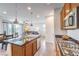 Modern kitchen featuring stainless steel appliances, granite countertops, and an open floor plan at 12536 Blissful Sky St, Las Vegas, NV 89138