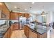 Open kitchen features granite countertops, stainless steel appliances, and center island at 12536 Blissful Sky St, Las Vegas, NV 89138
