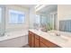 Luxurious main bathroom with double vanity, soaking tub, and glass-enclosed shower for a spa-like experience at 12536 Blissful Sky St, Las Vegas, NV 89138