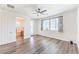 Spacious main bedroom with hardwood floors, ceiling fan, a balcony, and ensuite bathroom access at 12536 Blissful Sky St, Las Vegas, NV 89138