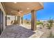 Spacious covered patio with pavers and outdoor ceiling fans overlooking the backyard at 12536 Blissful Sky St, Las Vegas, NV 89138